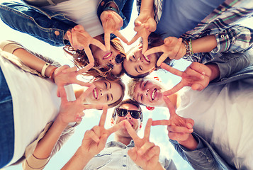 Image showing group of teenagers showing finger five