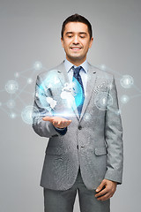Image showing happy businessman in suit showing global network