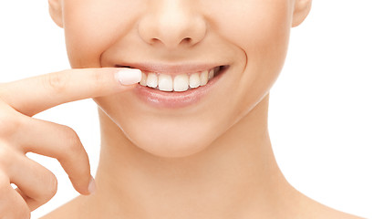 Image showing beautiful woman pointing to teeth