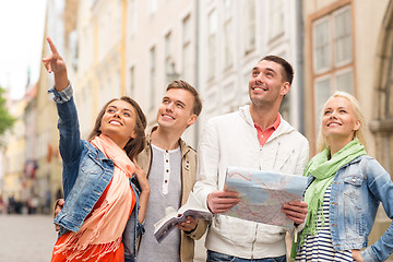 Image showing group of smiling friends with city guide and map