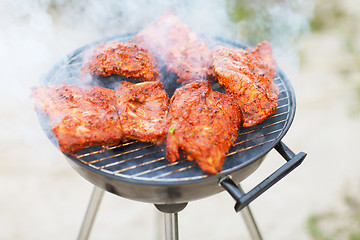 Image showing close up of meat on barbecue grill outdoors