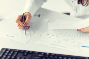 Image showing woman hand filling in blank paper or document