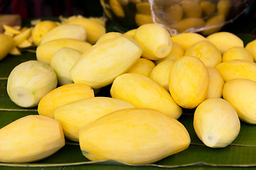 Image showing peeled mango at street market