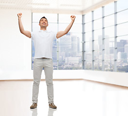 Image showing happy man with raised hands