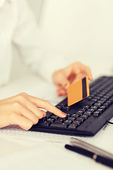 Image showing businesswoman with laptop using credit card