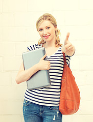 Image showing smiling teenage girl with laptop