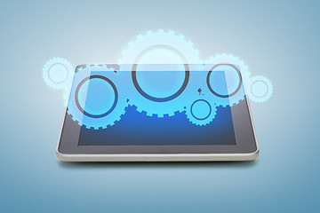 Image showing tablet pc with cogwheel icon over screen