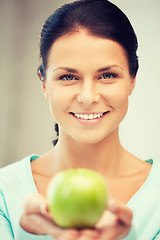 Image showing lovely housewife with green apple