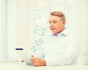 Image showing old man with tablet computer at home