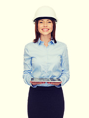 Image showing young businesswoman in white helmet with tablet pc