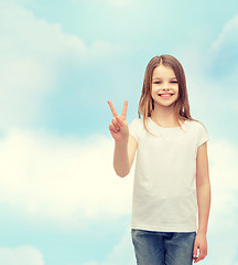 Image showing little girl in white t-shirt showing peace gesture