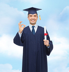 Image showing smiling adult student in mortarboard with diploma