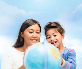 Image showing mother and daughter with globe