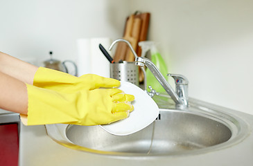 Image showing close up of woman hands washing dishes in kitchen