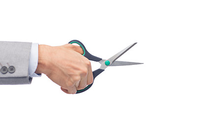 Image showing close up of businessman hand holding scissors