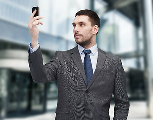 Image showing young businessman with smartphone