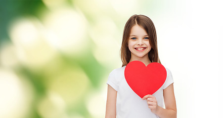 Image showing beautiful little girl sitting at table