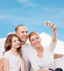 Image showing happy family with camera at home