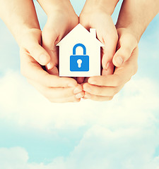 Image showing hands holding paper house with lock