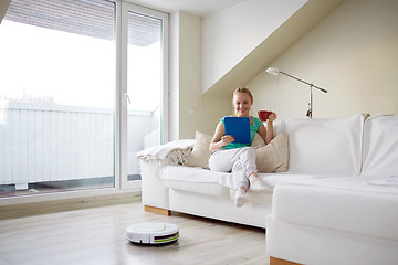 Image showing happy woman with tablet pc drinking tea at home