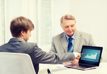 Image showing older man and young man with laptop computer