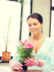 Image showing lovely housewife with flower