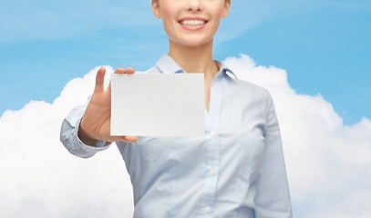 Image showing smiling businesswoman showing white blank card