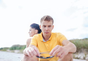 Image showing unhappy couple sitting on beach