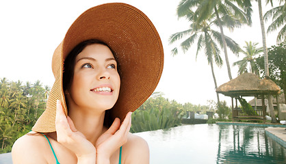 Image showing happy young woman in straw hat on tropical beach