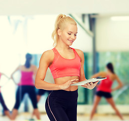 Image showing smiling sporty woman with tablet pc computer