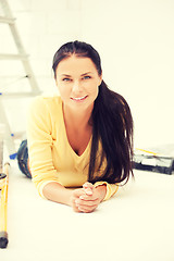 Image showing lovely housewife making repairing works