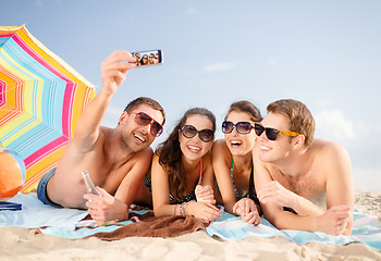 Image showing group of friends taking selfie with cell phone