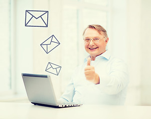 Image showing old man with laptop computer showing thumbs up