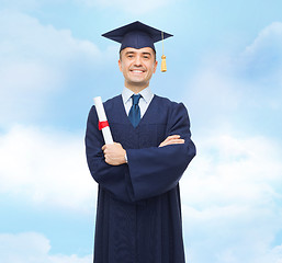 Image showing smiling adult student in mortarboard with diploma