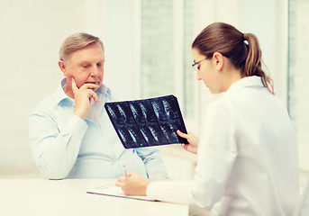 Image showing female doctor with old man looking at x-ray