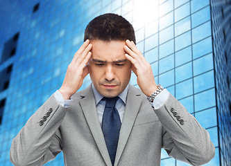 Image showing businessman in suit having head ache
