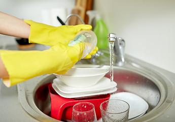 Image showing close up of woman hands washing dishes in kitchen