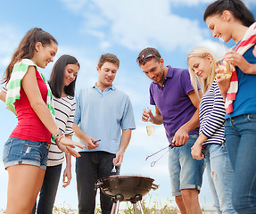 Image showing group of friends having picnic on beach