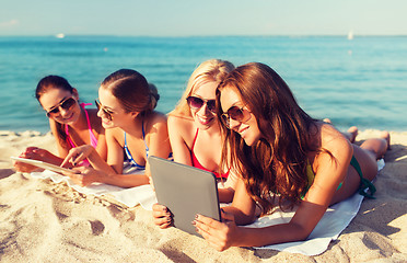 Image showing group of smiling young women with tablets on beach