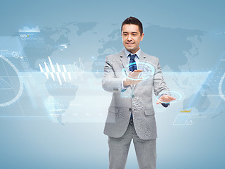 Image showing happy businessman working with virtual screens