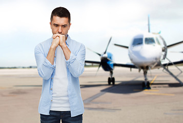 Image showing man thinking over airplane on runway background