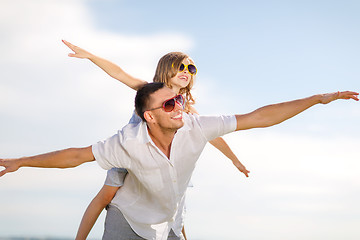 Image showing happy father and child in sunglasses over blue sky