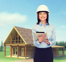 Image showing young smiling businesswoman in white helmet