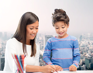 Image showing happy mother and daughter drawing with pencils