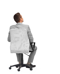 Image showing businessman sitting in office chair from back