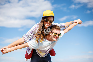 Image showing smiling teenagers in sunglasses having fun outside