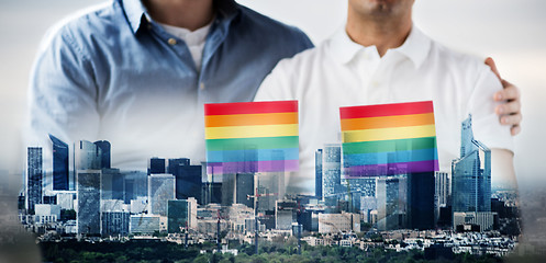 Image showing close up of male gay couple holding rainbow flags