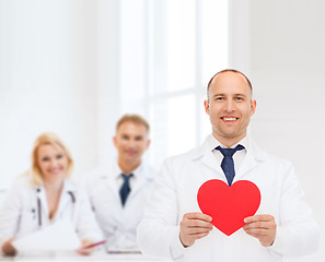 Image showing smiling male doctor with red heart