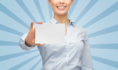 Image showing smiling businesswoman showing white blank card