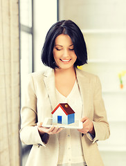 Image showing woman holding tablet pc with house illustration